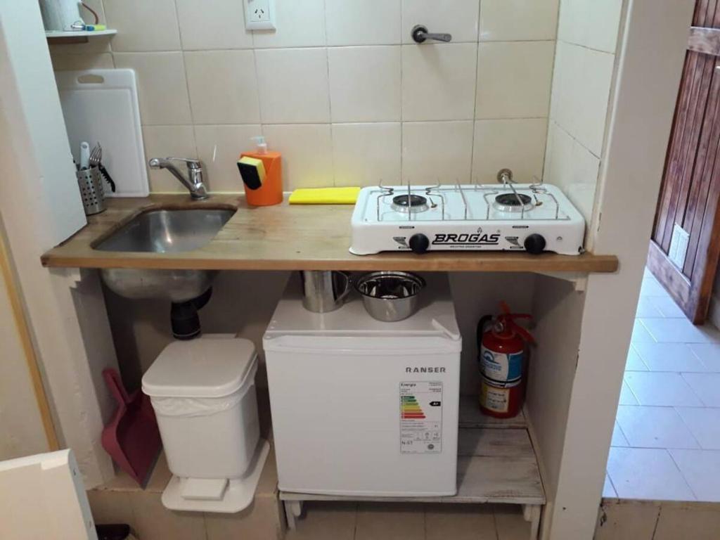 a small kitchen with a sink and a stove at Trabun in San Martín de los Andes