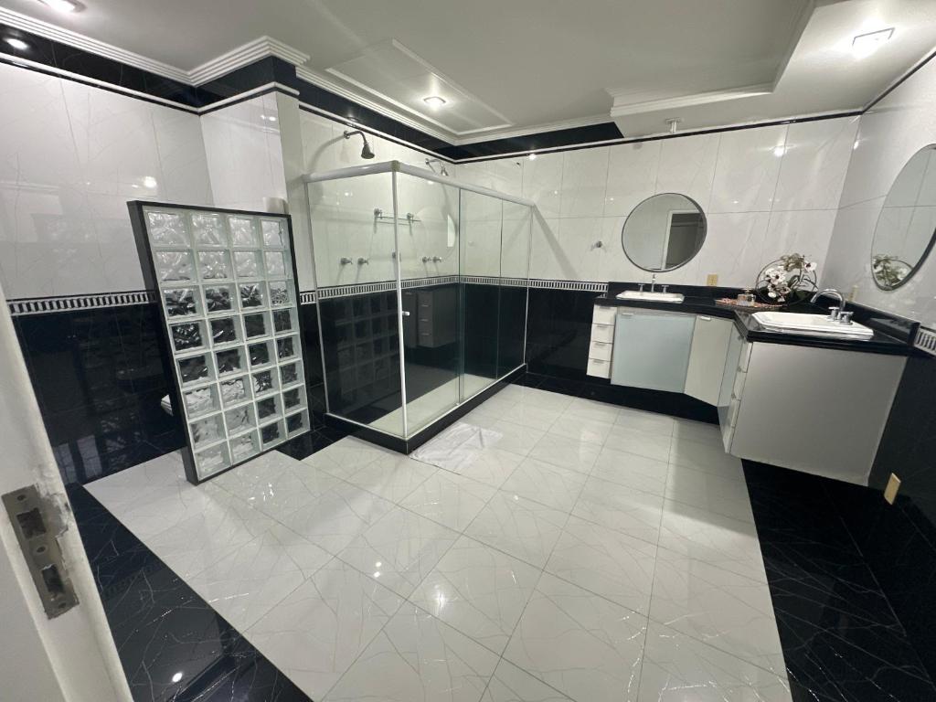 a large bathroom with a shower and a sink at Hotel Pousada Irmaos Freyhardt in Rio de Janeiro
