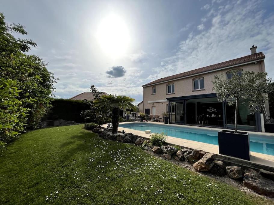 a house with a swimming pool in a yard at Villa Reims Champagne Lavannes Vineyard in Lavannes