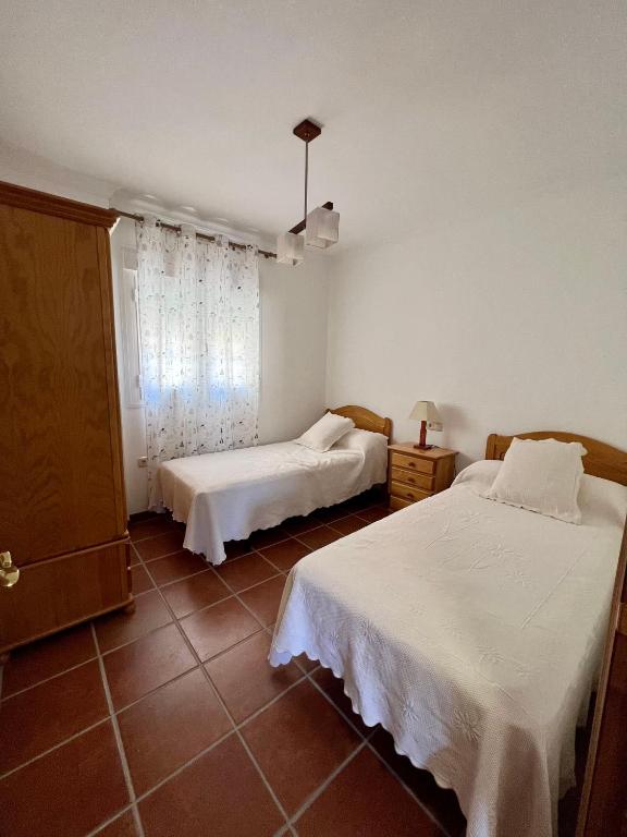 Postel nebo postele na pokoji v ubytování CASA RURAL VELEFIQuE