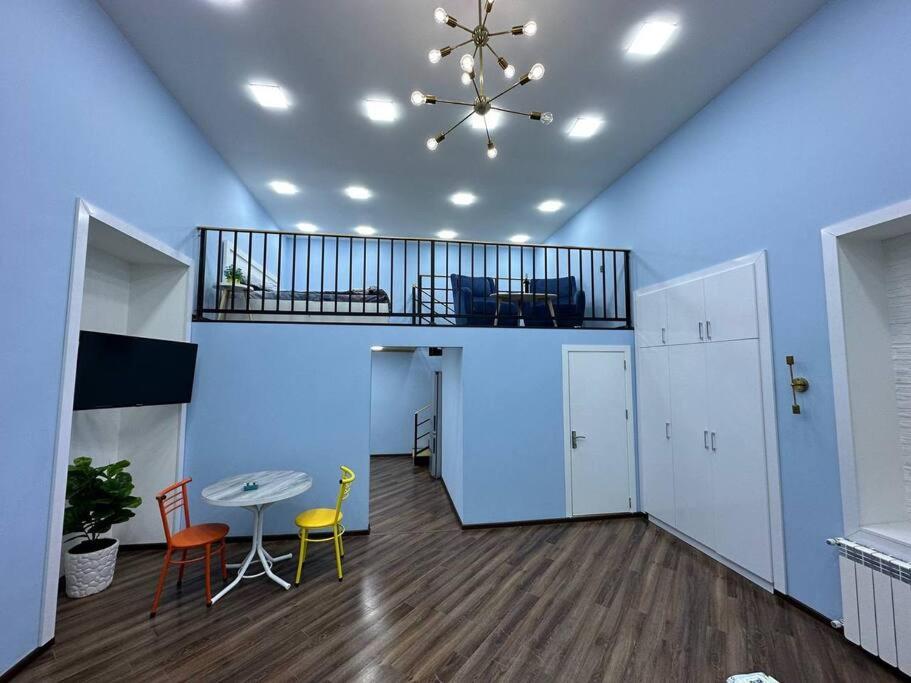 a room with a table and chairs and a ceiling at Turquoise Apartment in Baku