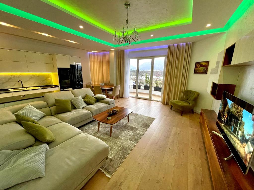 a living room with a couch and a table at Queen’s Luxury Apartments Lake in Tirana