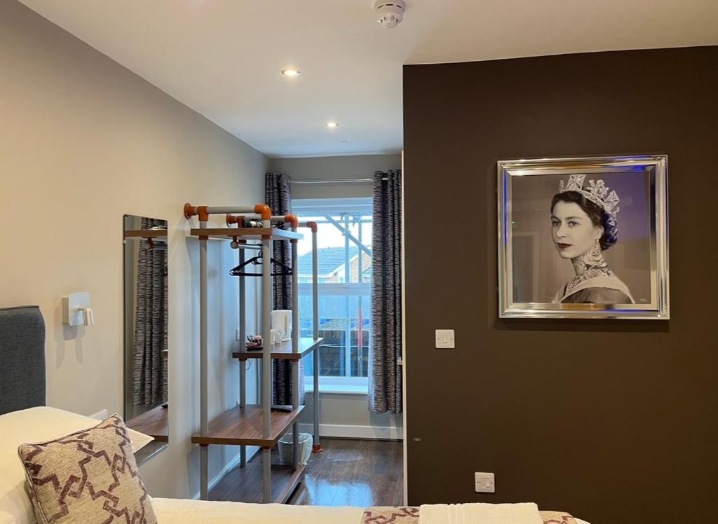 a room with a picture of a woman on the wall at The Vine Hotel Chapel st Leonards in Skegness