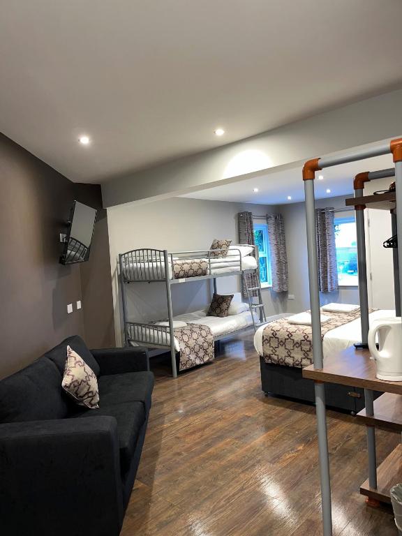 a living room with two bunk beds and a couch at The Vine Hotel Chapel st Leonards in Skegness