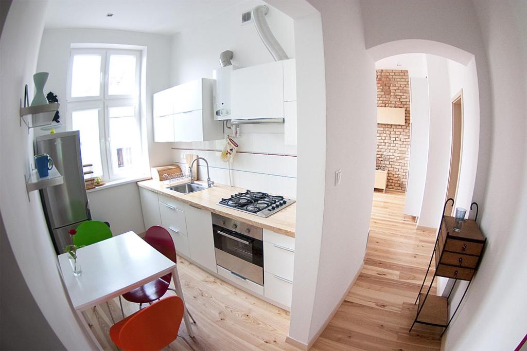 a kitchen with a sink and a stove top oven at Classic Apartment with Private Sauna in Old Town in Gdańsk