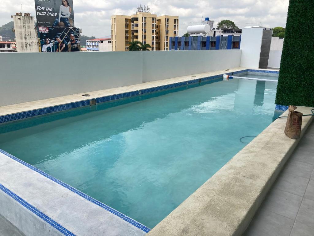 a swimming pool on the roof of a building at Lovely flat with pool in city center in Panama City
