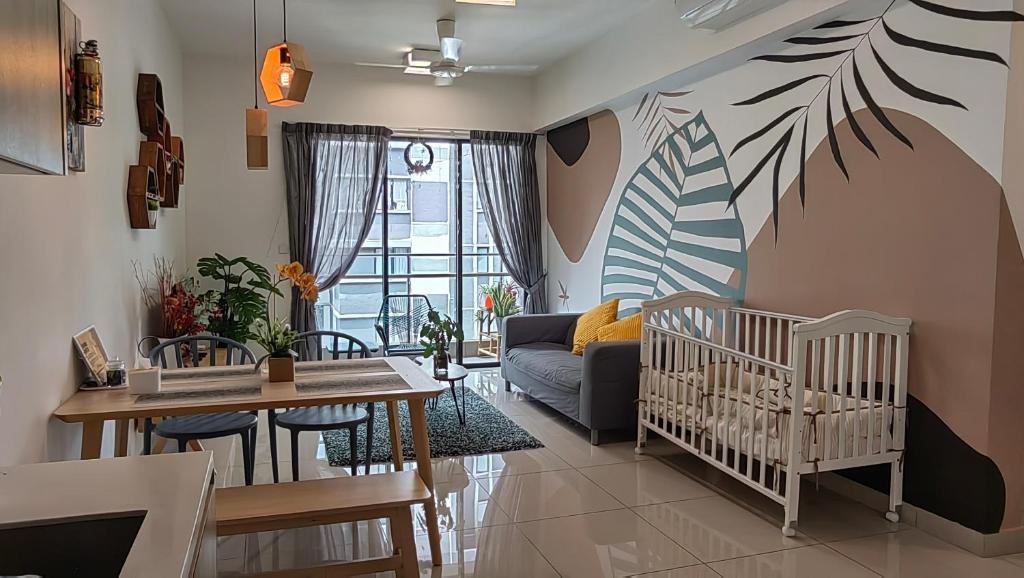 a living room with a couch and a crib at NORDIC Geniehome2BR1studio Free 90mbps WIFI and Carpark at Utropolis Suite Shah Alam in Shah Alam