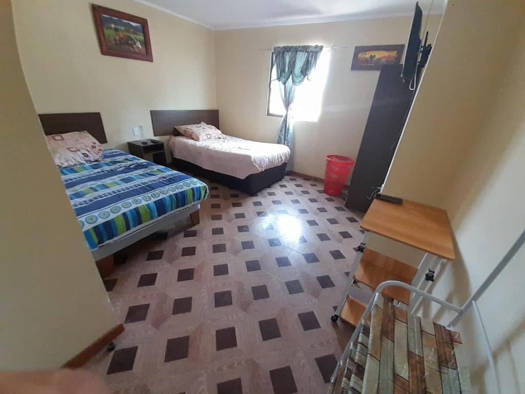 Cama o camas de una habitación en Hostal MIRAMAR En Pleno Centro de Pozo Almonte