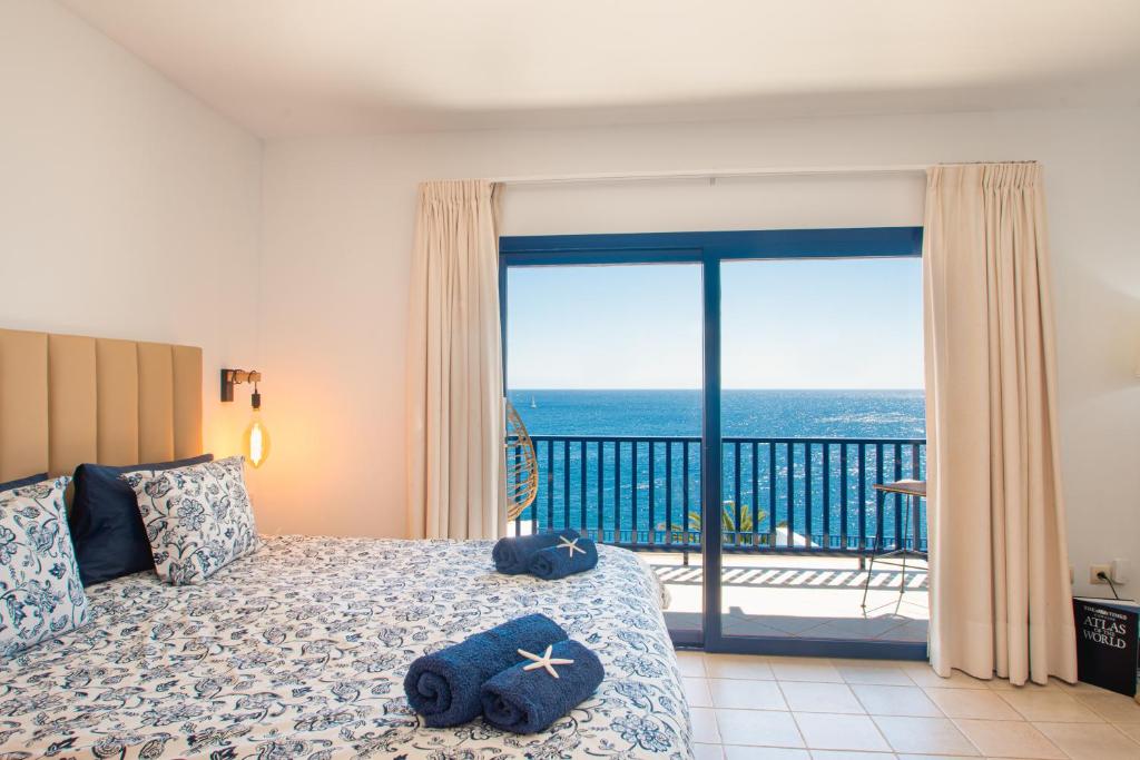 a bedroom with a bed with a view of the ocean at FRONTLINE VILLA 26, Modern Coastal Design with Amazing Views in Puerto Calero