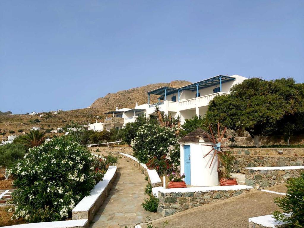 a house on the side of a hill with plants at Medusa Accommodation in Livadakia