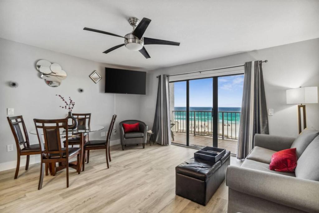 a living room with a table and a dining room at The Summit 531 in Panama City Beach