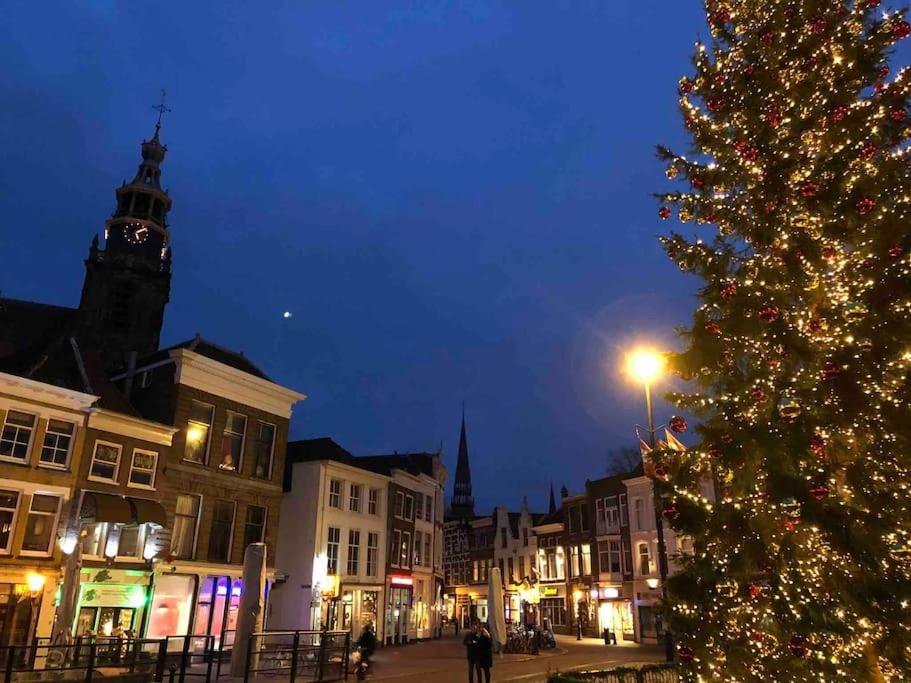 a christmas tree on a city street with a clock tower at Apartment City Center Gouda in Gouda