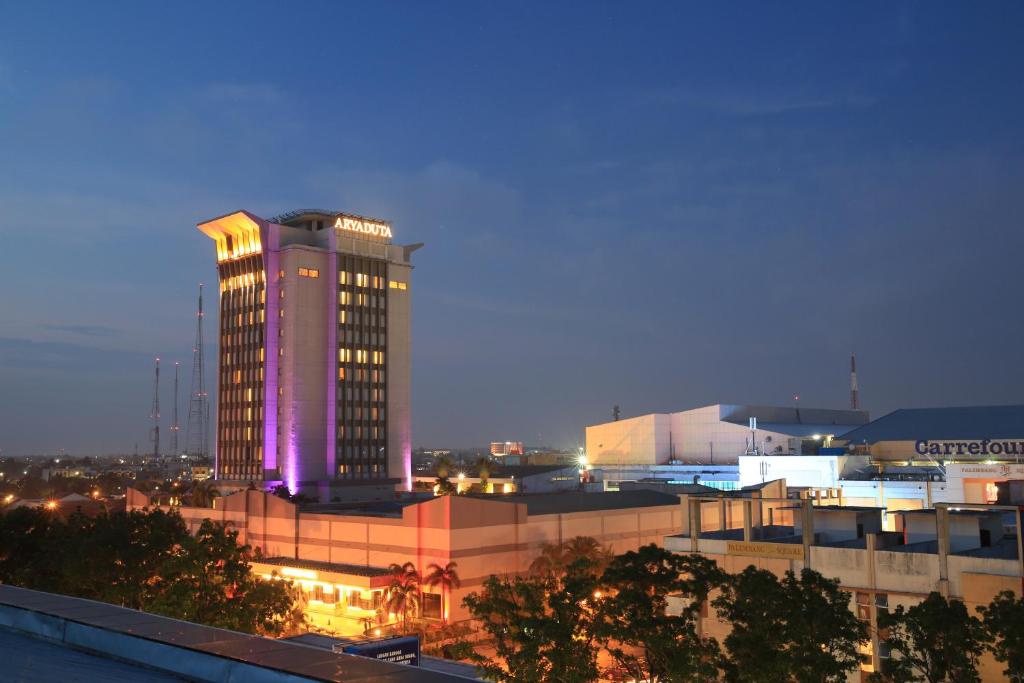 a lit up building with lights on top of it at Aryaduta Palembang in Palembang