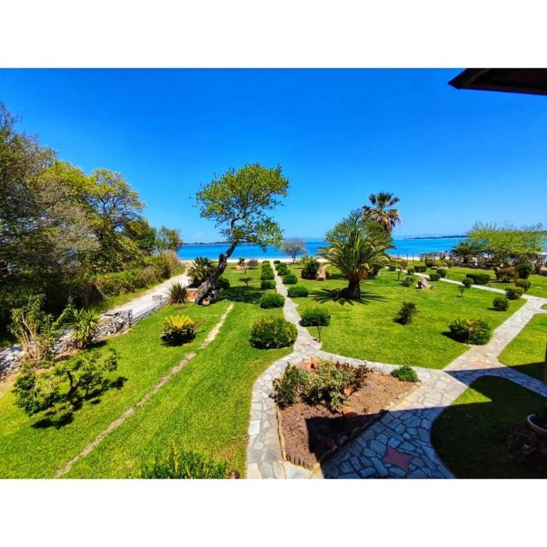 a view of a park with the ocean in the background at Stamos Apartments and Studios in Vourvourou