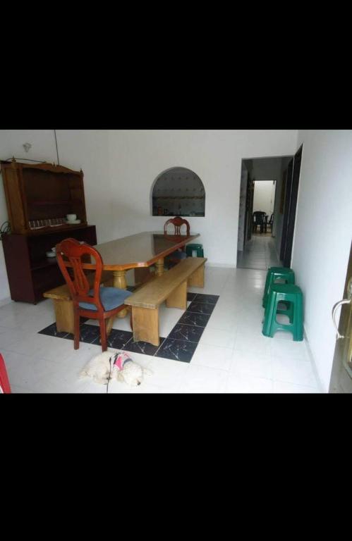 a living room with a table and a chair and a dog at Casa el remanso in Acacías