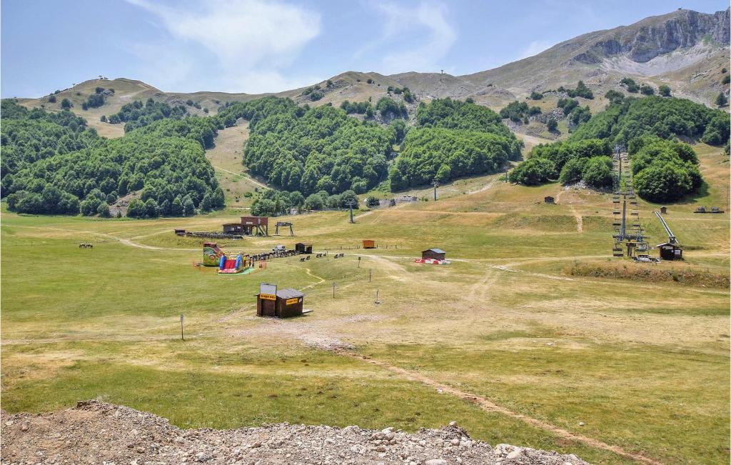 an open field with a playground with mountains in the background at 2 Bedroom Cozy Apartment In San Massimo in San Massimo