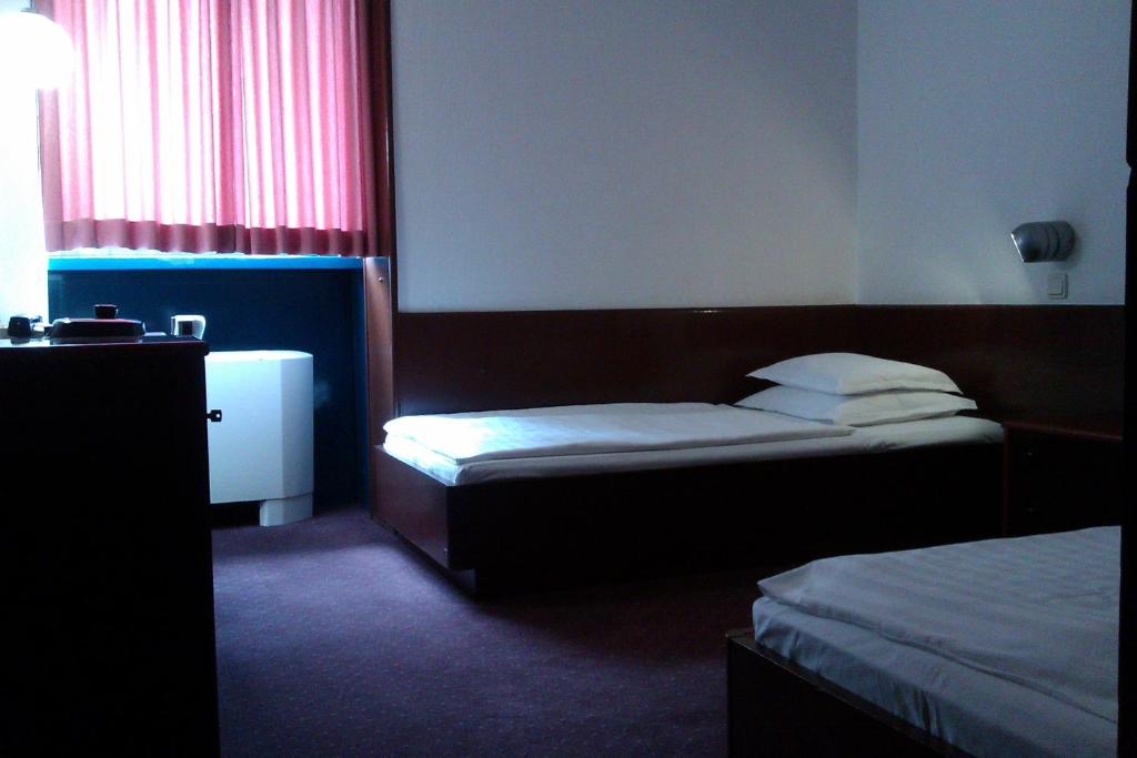 Postel nebo postele na pokoji v ubytování Hotel Laguna Zagreb
