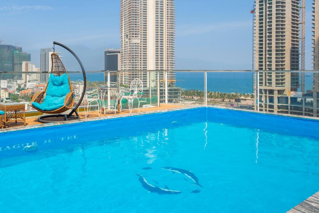 a swimming pool with a view of the city at Prague Hotel in Da Nang