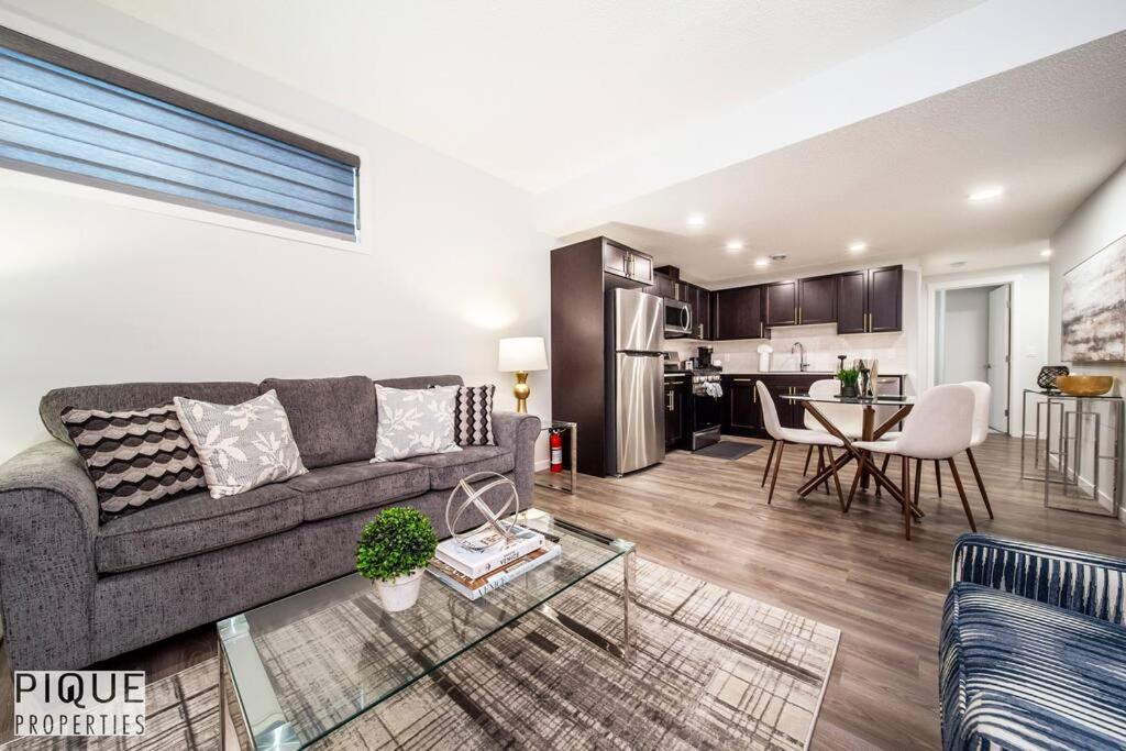 a living room with a couch and a table at NEW Modern 2 Bedroom Suite, Complimentary Netflix, Sleeps 4 in Edmonton