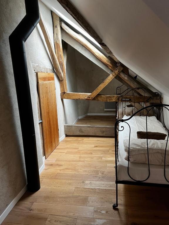 an attic room with a bed in a attic at Gîte des 3 Marchands in Buzançais