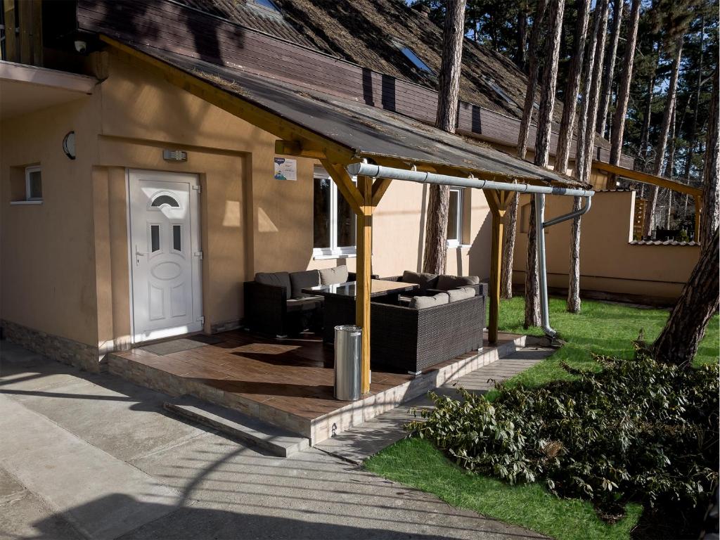 a house with a porch with a white door at Grátisz Apartman Siófok in Siófok