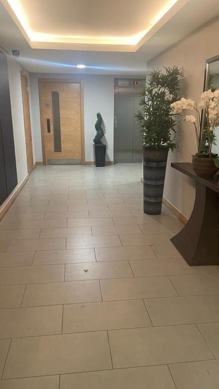 a hallway with a large tile floor in a building at Luxurious Furnished Property in Stanmore