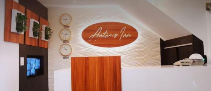 una habitación con relojes en la pared en una oficina en Anton's Inn, en Balanga