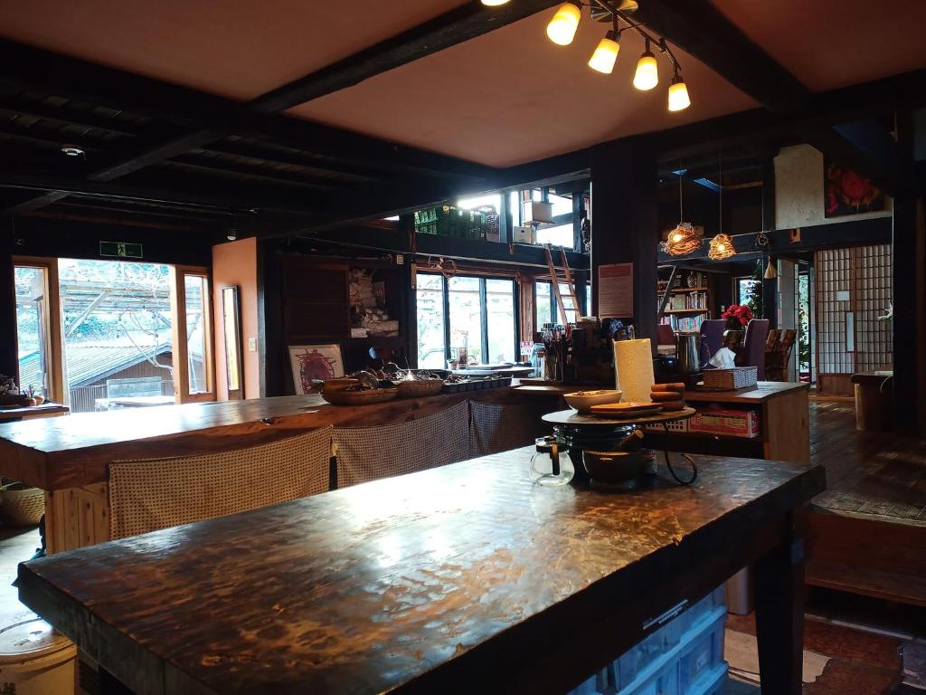 a bar with a large wooden counter in a restaurant at Yokomura Eco-Lodge in Uenohara