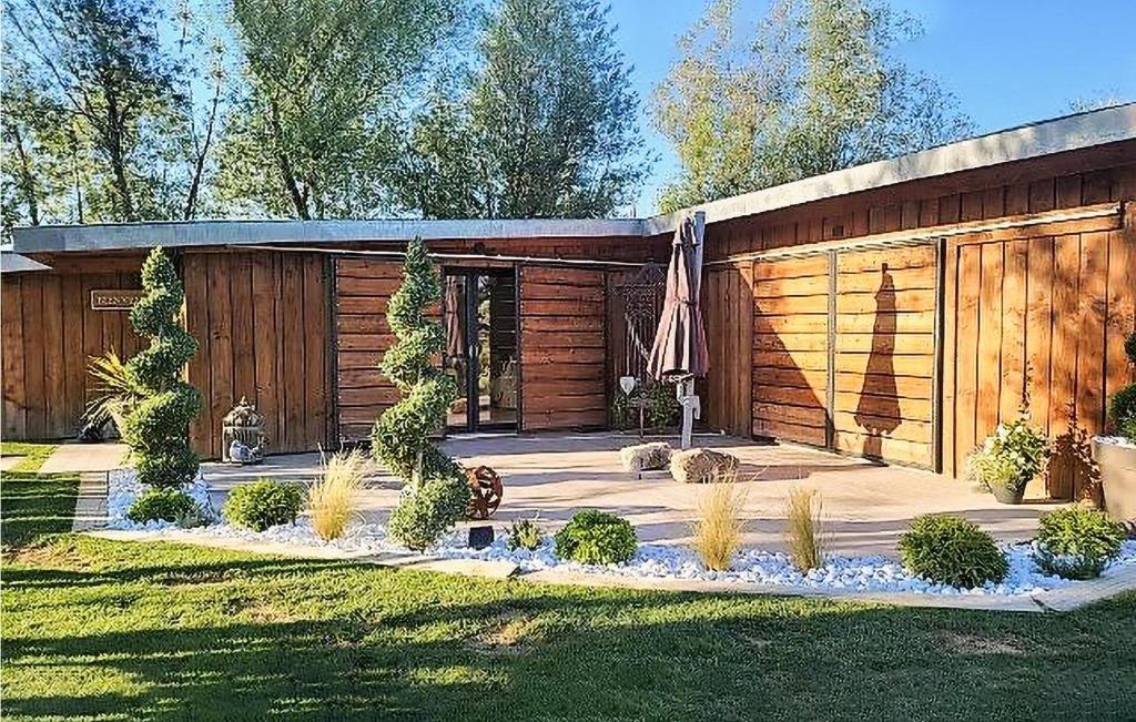 a backyard with a wooden cabin with an umbrella at Beautiful Home In Rognonas With Outdoor Swimming Pool in Rognonas