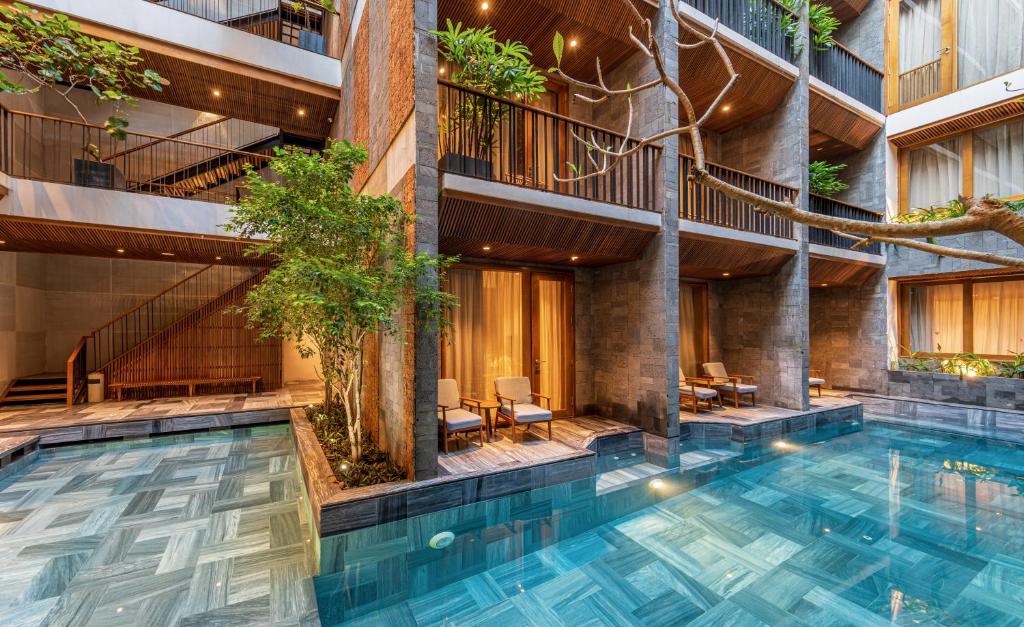 an indoor pool in a building with a staircase at Daisy Boutique Hotel in Da Nang
