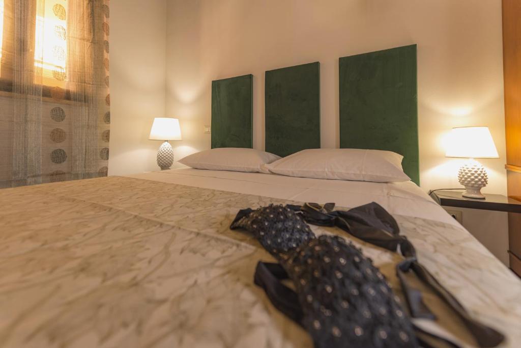 a bed with two umbrellas on top of it at AMUNI' Apartments in Trabia