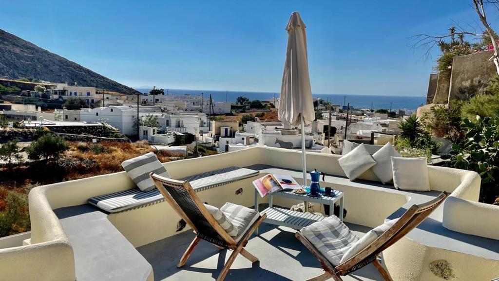 a patio with chairs and a table with a view of a city at Barbarossa Suites in Emporio