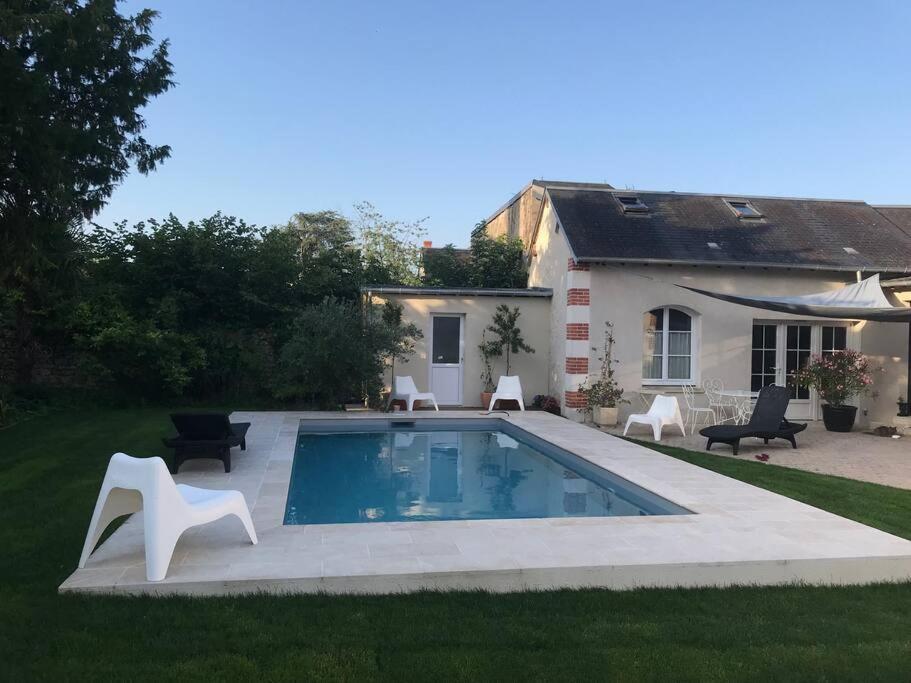 a swimming pool in the yard of a house at maisonette cosy Blois in Blois