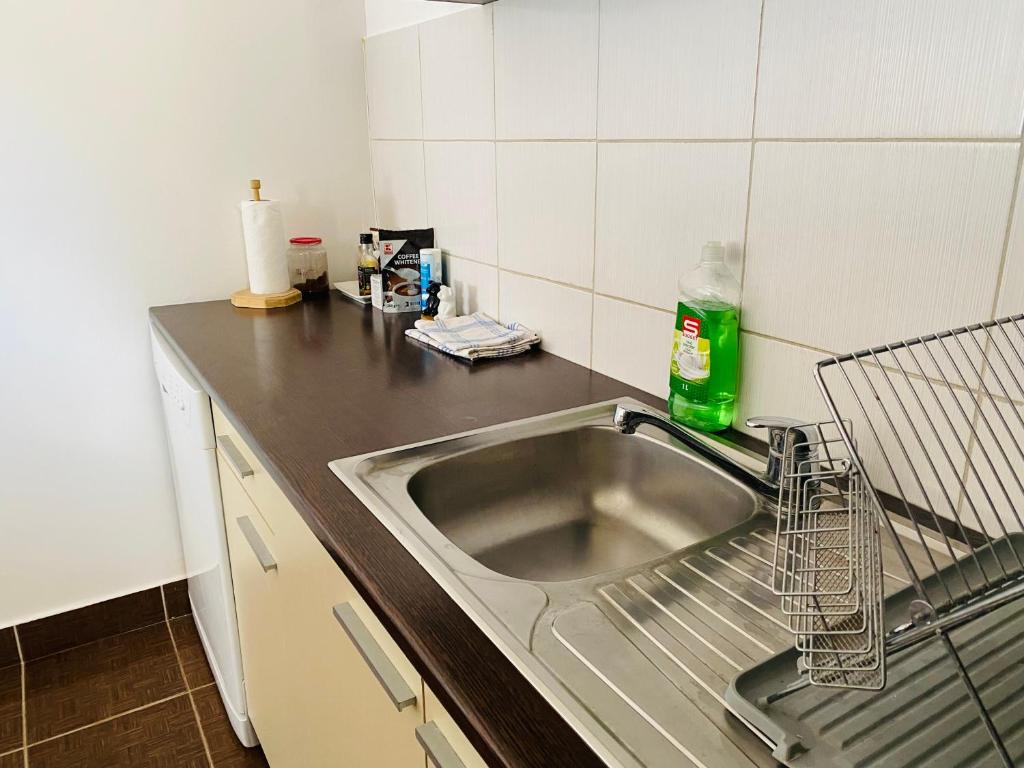 a kitchen with a sink and a counter top at Apartment Zvečaj in Đakovo