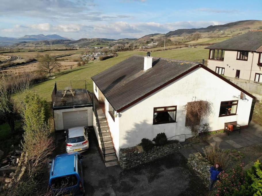 a white house with a car parked in front of it at Halsteads: peaceful location, stunning views in Soutergate