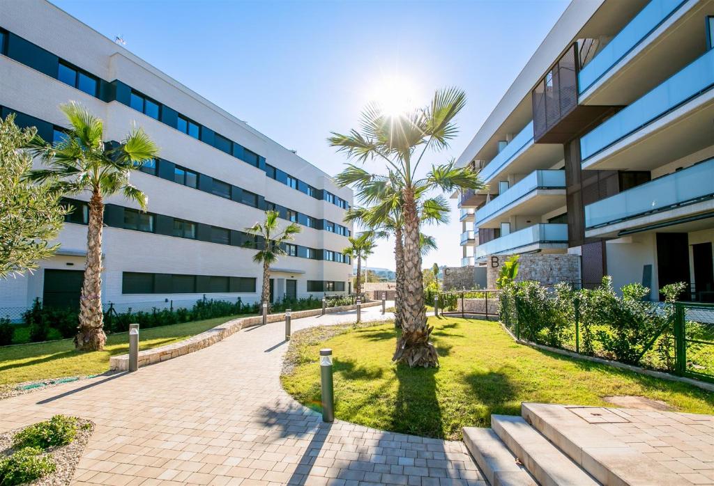 a building with palm trees in front of it at Prime Spanish Holidays - Arenal Dream in Jávea