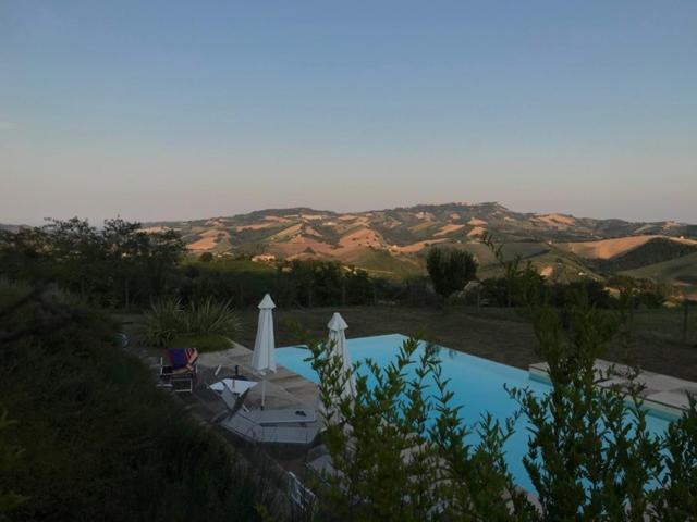 a swimming pool with a view of the desert at Casa Vitale in Carassai
