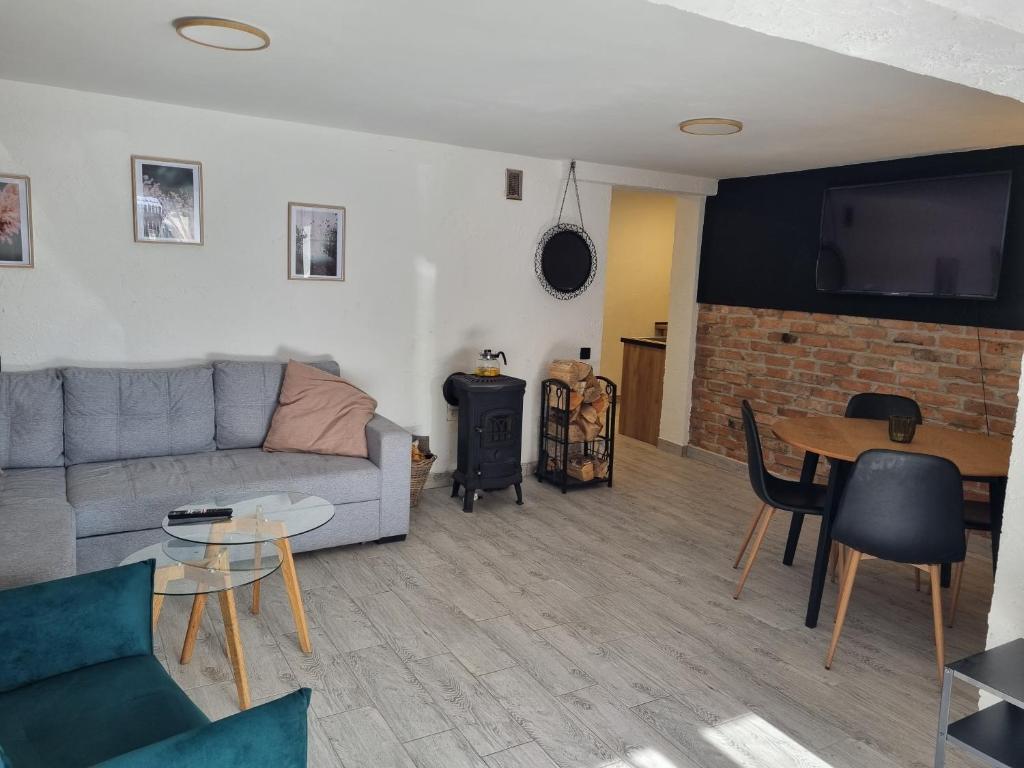 a living room with a couch and a table at Apartament Nova Kamienica - Studio in Łagów