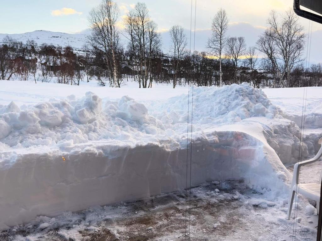 a large pile of snow on the side of a window at Apartment HOVDEN II in Hovden