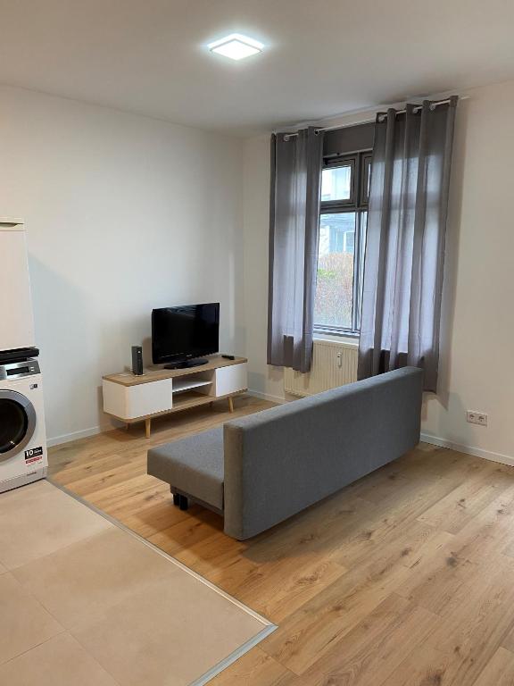 a living room with a couch and a tv at Wohnung in Nürtingen in Nürtingen