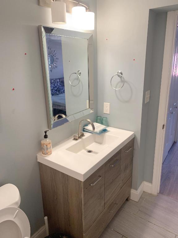 a bathroom with a sink and a mirror at Beautiful bedroom with balcony in Baltimore