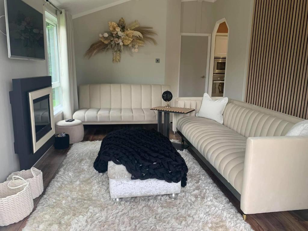 a living room with a couch and a table at The Lodge at Haggerston Castle in Beal