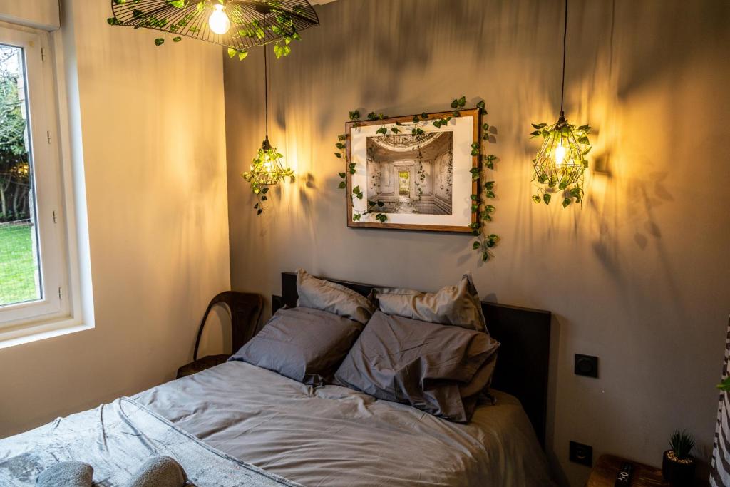 Łóżko lub łóżka w pokoju w obiekcie SUITE INDUS - JARDIN, NETFLIX et PARKING - Le Manoir aux Pommes