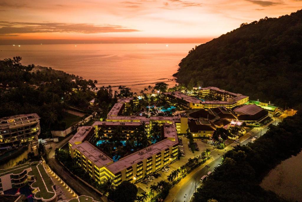 an aerial view of a resort near the ocean at night at Phuket Marriott Resort & Spa, Merlin Beach in Patong Beach