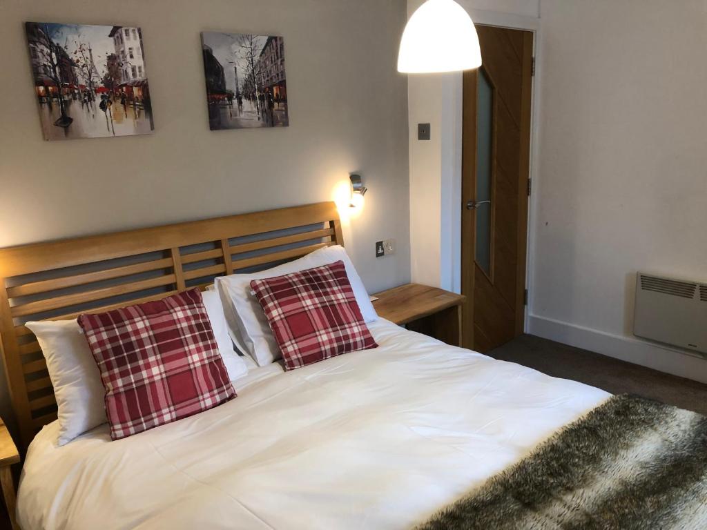 a bedroom with a bed with two pillows on it at Townhouse in Cardigan in Cardigan