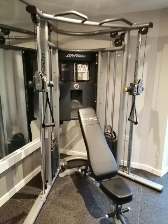 a gym with a chair in front of a machine at Newlands Holidays in Bridport