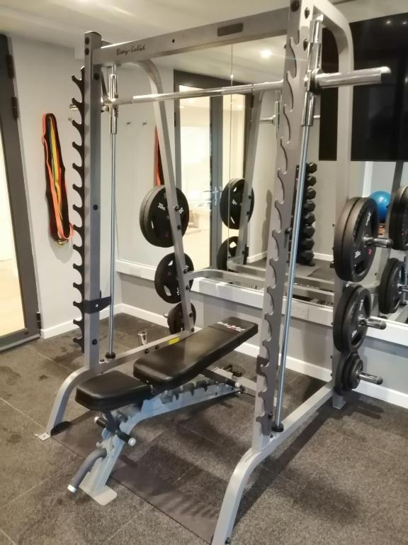 a gym with a bench and weights at Newlands Holidays in Bridport