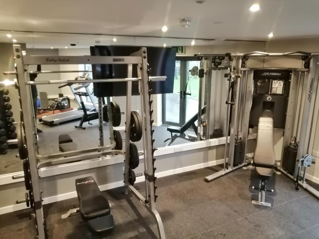 a room with a gym with two treadmills at Newlands Holidays in Bridport