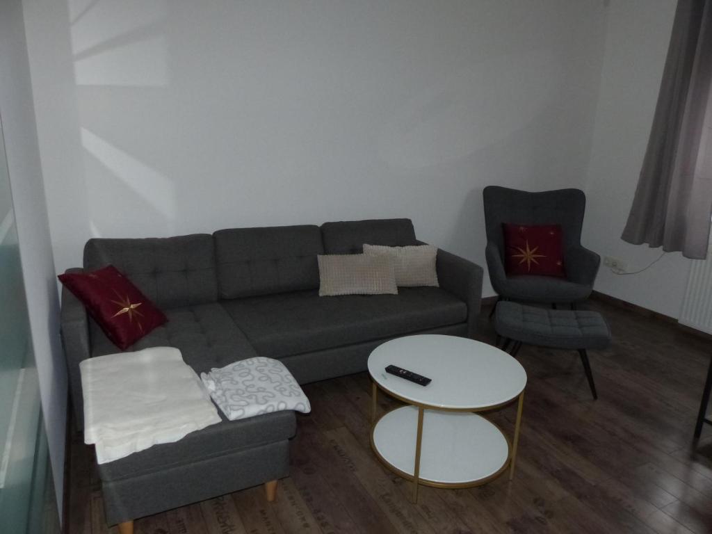 a living room with a couch and a chair at Ferienwohnung in Porta Westfalica