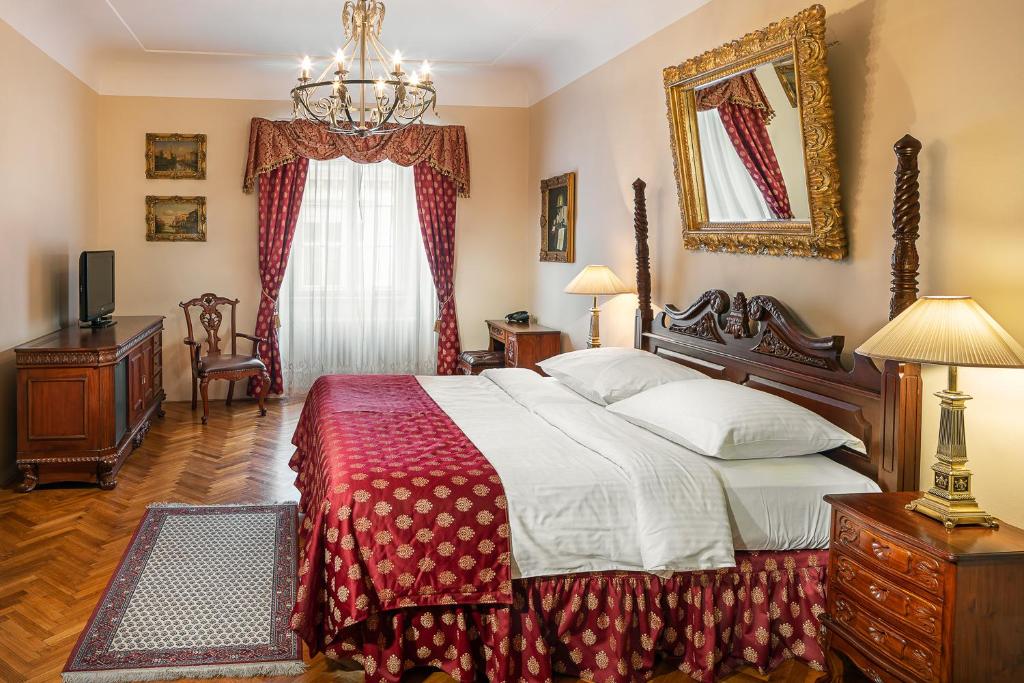 a bedroom with a large bed and a mirror at BHG Apartments Prague in Prague